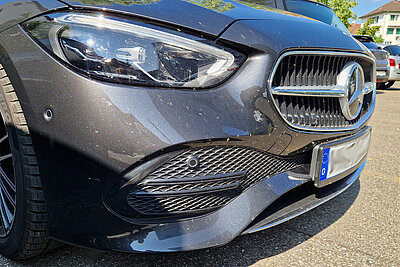 Die Front eines Autos mit zahlreichen Insektenüberresten.